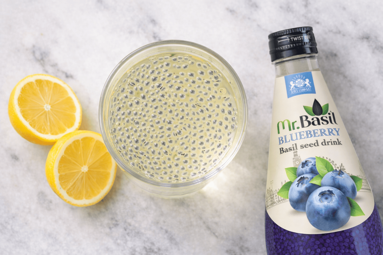 Close-up of soaked basil seeds floating in lemon drink showing clear gel coating on each seed