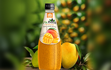 A close-up image of a Mr. Basil Mango flavored drink bottle with ripe mangoes in a lush orchard setting.